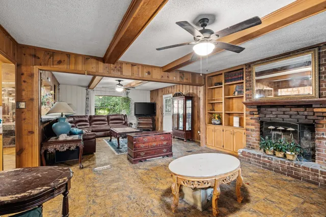 a living room with a fireplace furniture and a large window