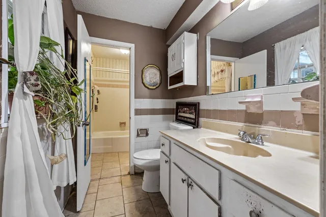 a bathroom with a sink a toilet and a mirror