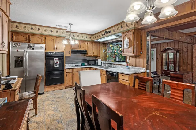 a large kitchen with a table and chairs