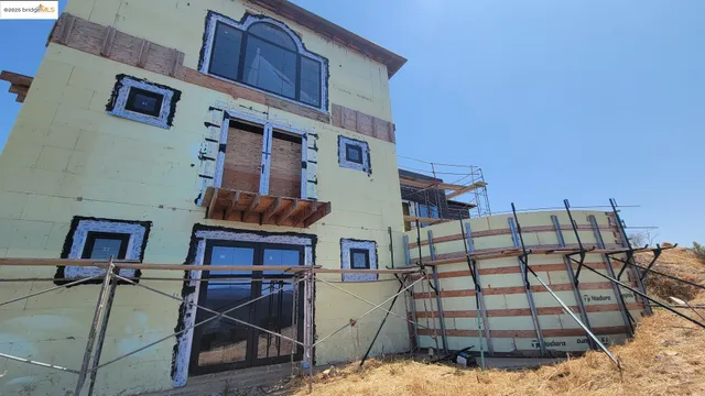 a view of a brick house with many windows