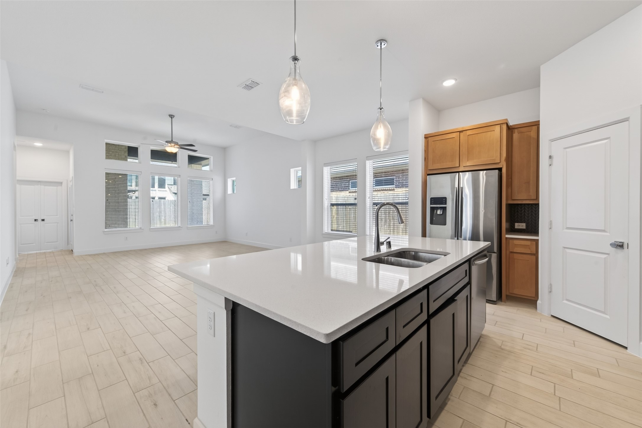 211 Amaranth Way Richmond, TX 77406 - Photo 18 of 26 a kitchen with kitchen island a sink stove and refrigerator