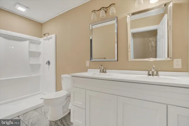 a bathroom with a granite countertop sink mirror and a bathtub