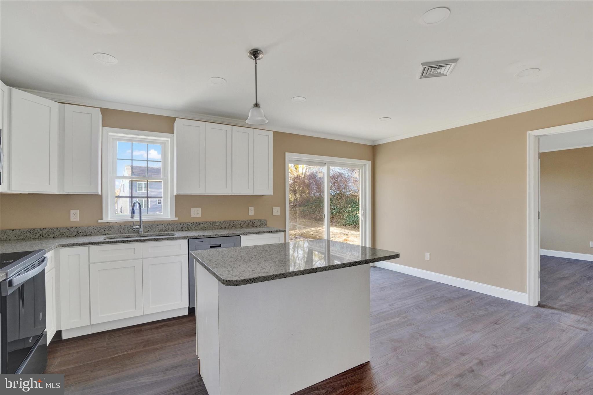 415 Lampeter Road Lancaster, PA 17602 - Photo 15 of 30 a kitchen with stainless steel appliances granite countertop a sink a stove a refrigerator and island with wooden floor