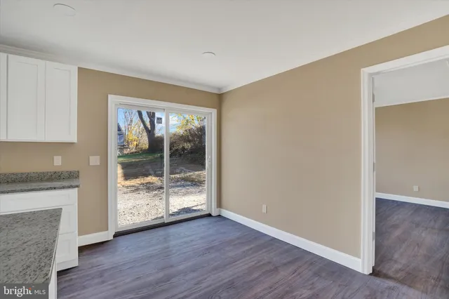 a view of a room with wooden floor and fireplace