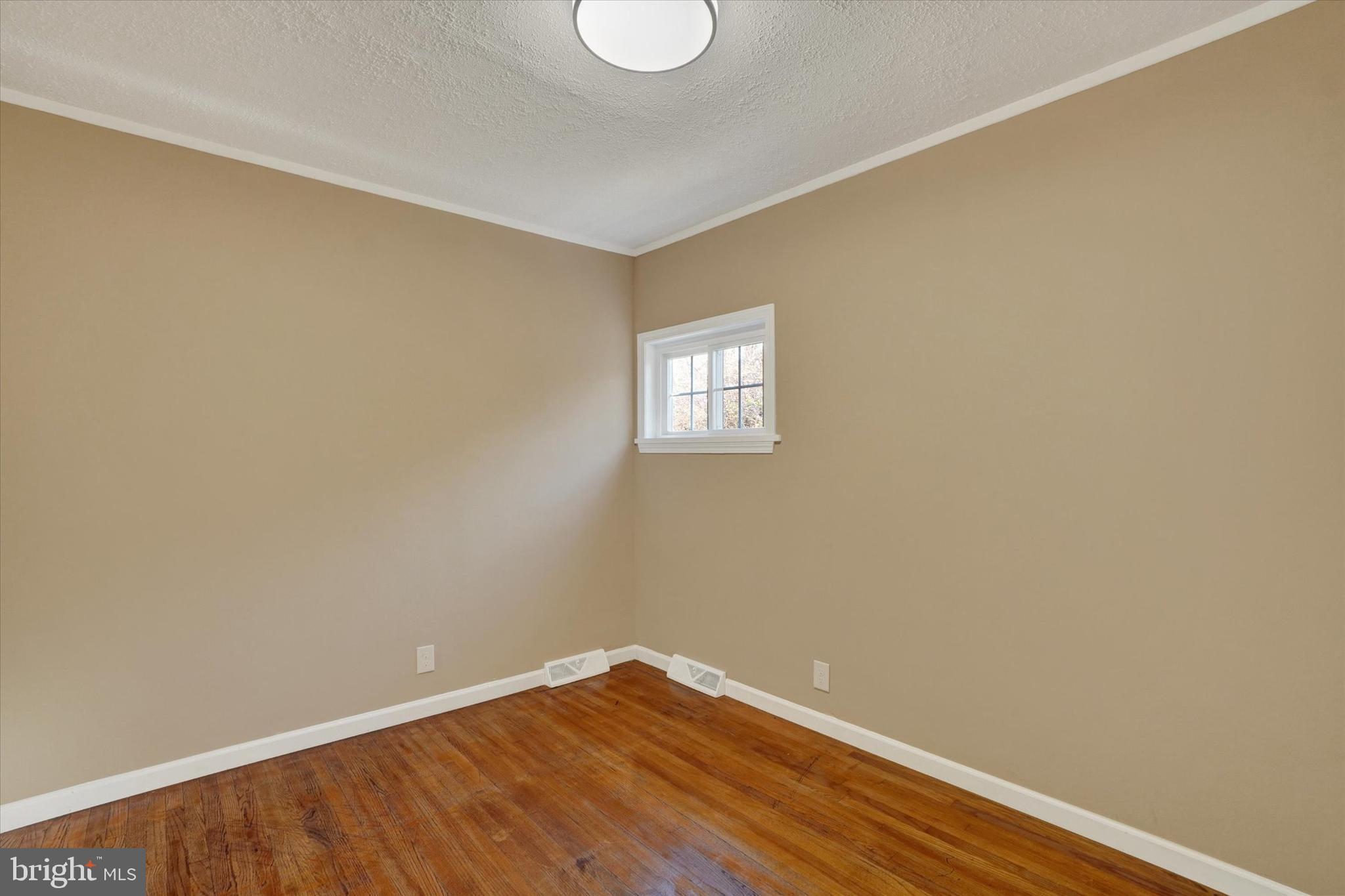 415 Lampeter Road Lancaster, PA 17602 - Photo 20 of 30 a view of an empty room with wooden floor and a window