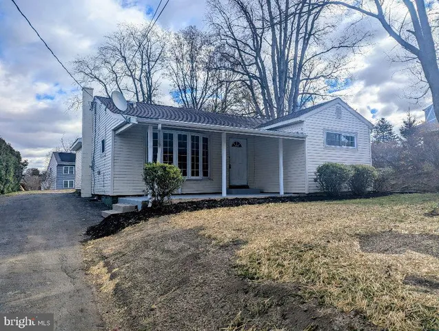 a view of a house with a yard covered in snow
