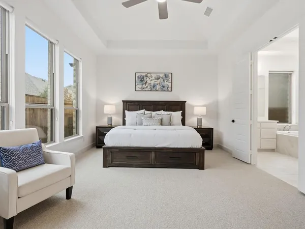 a bedroom with a large bed couch and a window