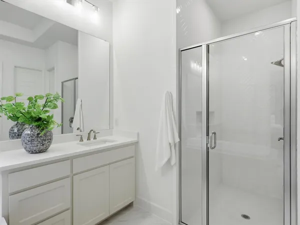 a bathroom with a double vanity sink and mirror