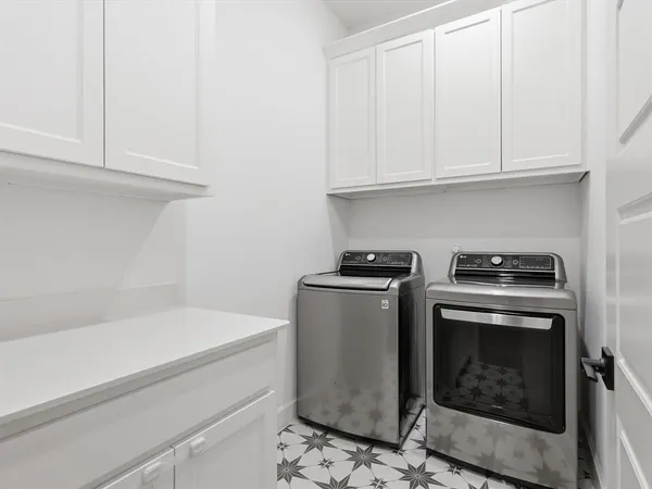 a utility room with sink dryer and washer