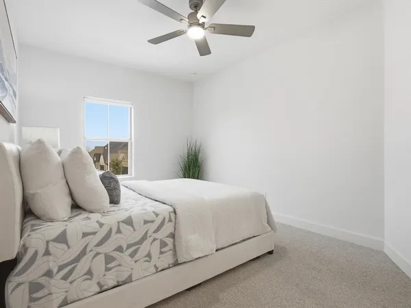 a bedroom with a bed and window