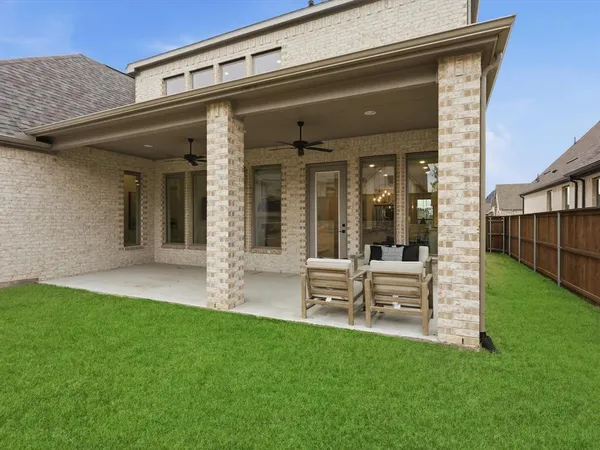 swimming pool with outdoor seating and yard