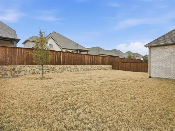 a view of wooden fence and a yard
