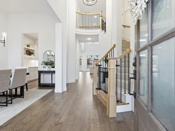 a view of entryway and hall with wooden floor