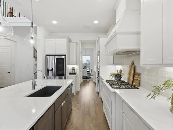 a kitchen with a sink stove and refrigerator