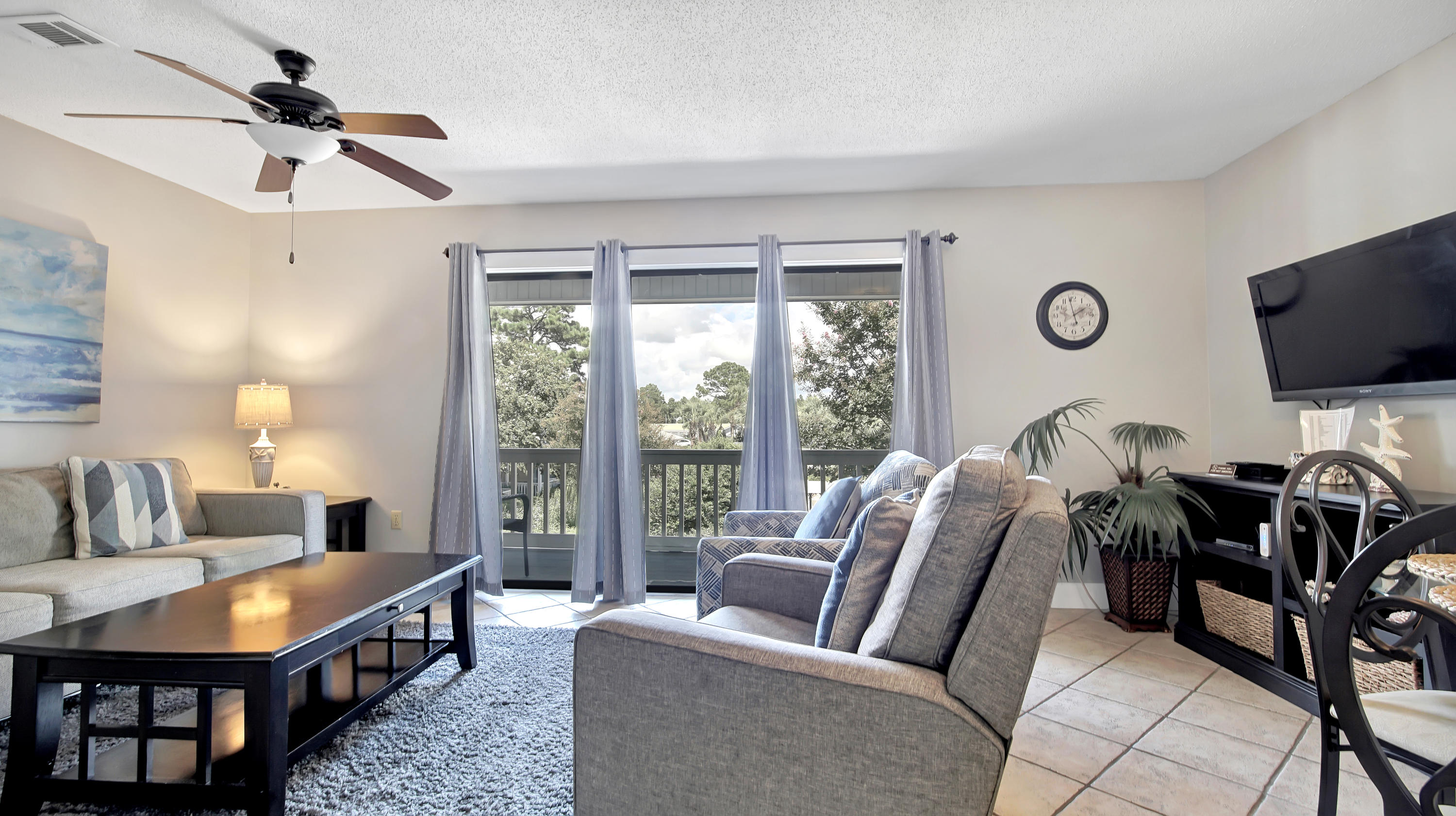 3799 East County Highway 30A, Unit F2 Santa Rosa Beach, FL 32459 - Photo 12 of 25 a living room with furniture a flat screen tv and a large window