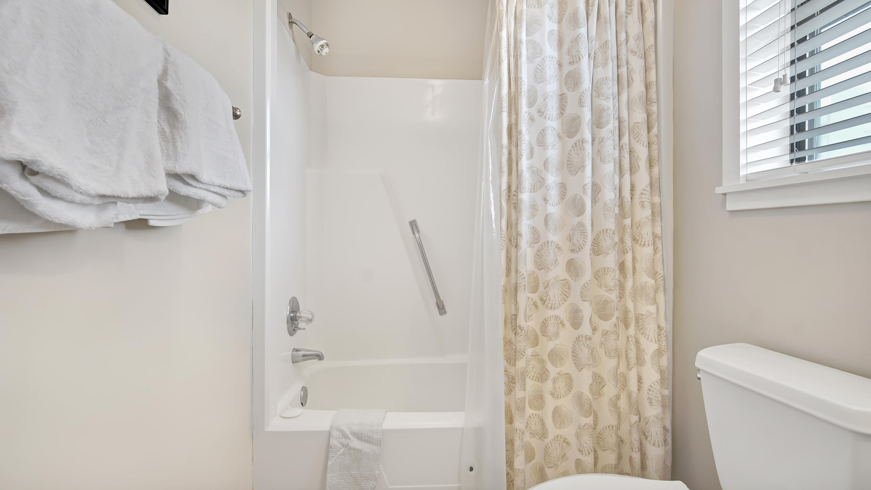 3799 East County Highway 30A, Unit F2 Santa Rosa Beach, FL 32459 - Photo 20 of 25 a bathroom with a shower curtain and a toilet