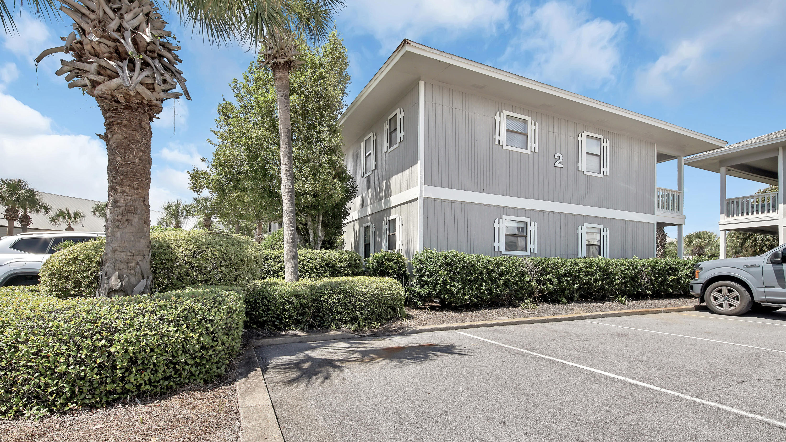 3799 East County Highway 30A, Unit F2 Santa Rosa Beach, FL 32459 - Photo 2 of 25 a front view of a house with yard and parking