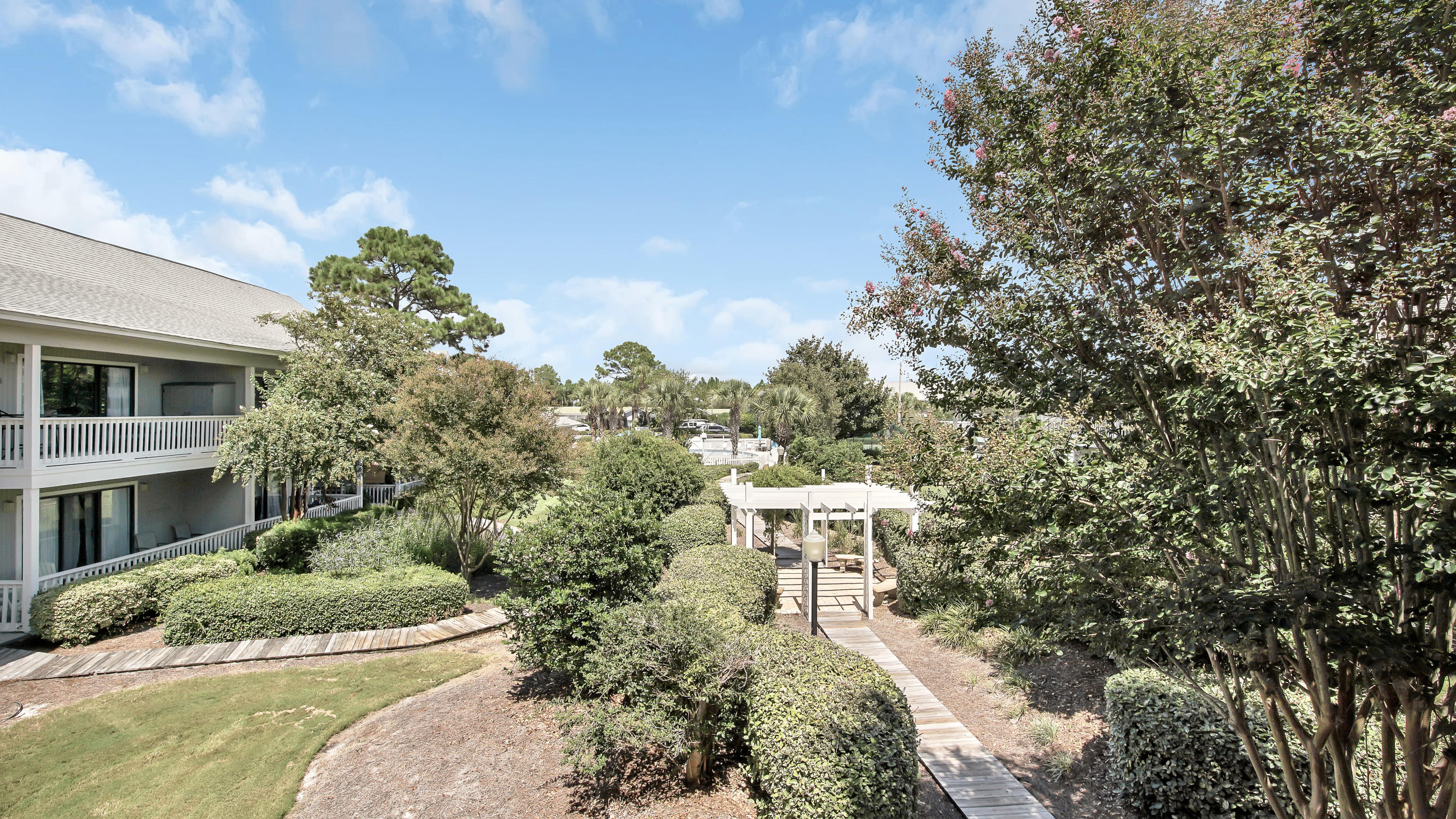3799 East County Highway 30A, Unit F2 Santa Rosa Beach, FL 32459 - Photo 22 of 25 a aerial view of a house with a yard and large trees