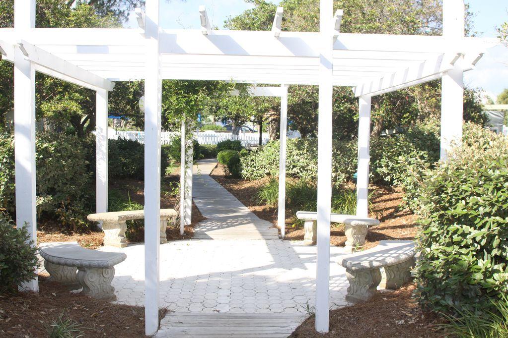 3799 East County Highway 30A, Unit F2 Santa Rosa Beach, FL 32459 - Photo 4 of 25 a view of a patio with table and chairs and potted plants