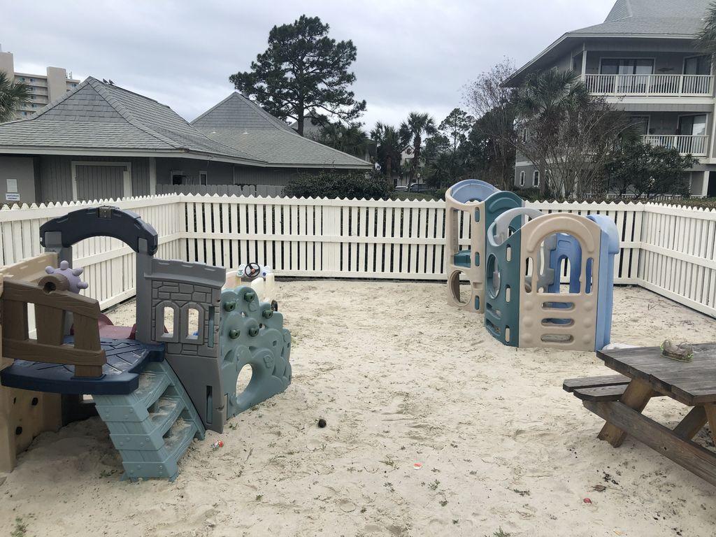 3799 East County Highway 30A, Unit F2 Santa Rosa Beach, FL 32459 - Photo 7 of 25 a view of a deck with table and chairs with wooden fence