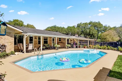 a view of a house with swimming pool and porch