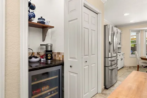 a kitchen with granite countertop a sink a stove and cabinets