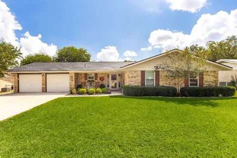 a front view of house with yard and outdoor seating
