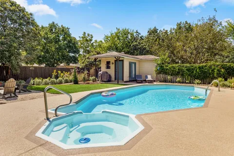 a view of a house with swimming pool and sitting area