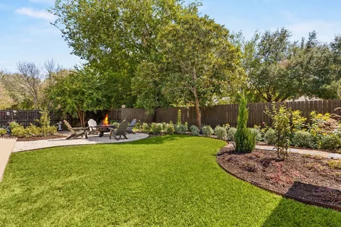 a view of a house with a swimming pool and sitting area