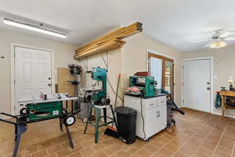 a view of a backyard with table and chairs and potted plants