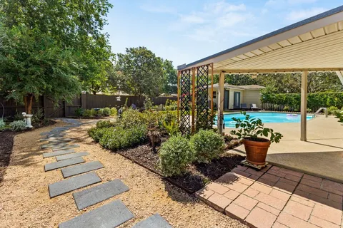 a view of a small house with backyard