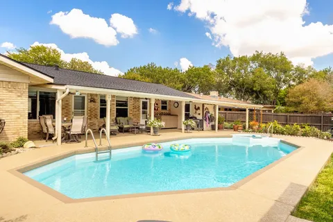 a view of a back yard with potted plants
