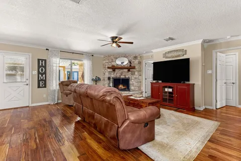a living room with furniture a flat screen tv and a fireplace