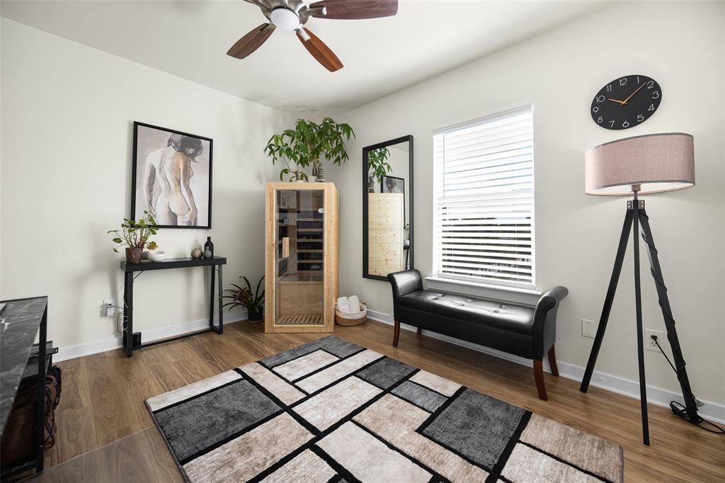 3922 Gilbert Avenue, Unit 214 Dallas, TX 75219 - Photo 15 of 27 Spacious room with wood-finish flooring, a ceiling fan, and a large window with horizontal blinds
