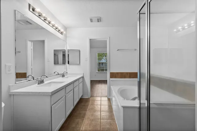 a bathroom with a double vanity sink and mirror