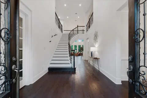 a view of entryway with wooden floor and stairs