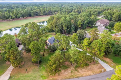 an aerial view of a house with swimming pool and garden