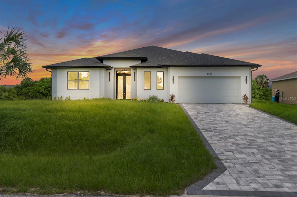 2328 Irondale Road North Port, FL 34287 - Photo 1 of 45 a front view of a house with yard and green space