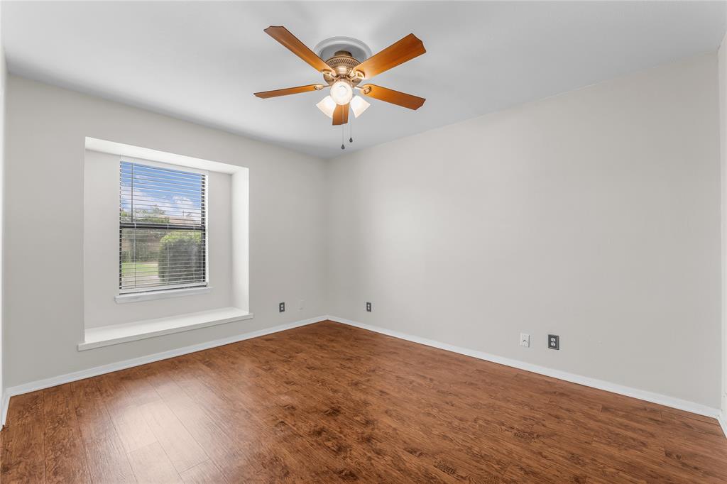 1409 Chapel Downs Waco, TX 76712 - Photo 11 of 20 an empty room with wooden floor and windows