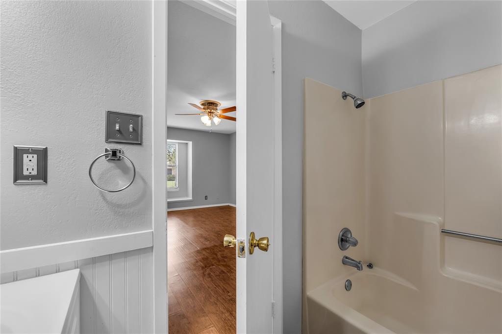 1409 Chapel Downs Waco, TX 76712 - Photo 13 of 20 a bathroom with a granite countertop bathtub and shower