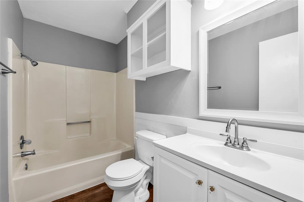 1409 Chapel Downs Waco, TX 76712 - Photo 15 of 20 a bathroom with a sink toilet vanity and shower
