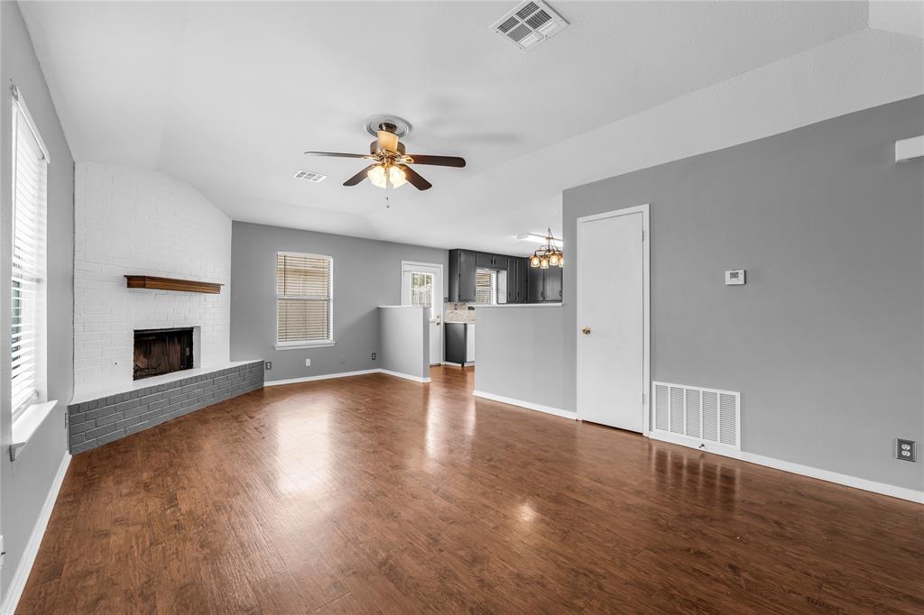 1409 Chapel Downs Waco, TX 76712 - Photo 2 of 20 a view of empty room with wooden floor and fireplace