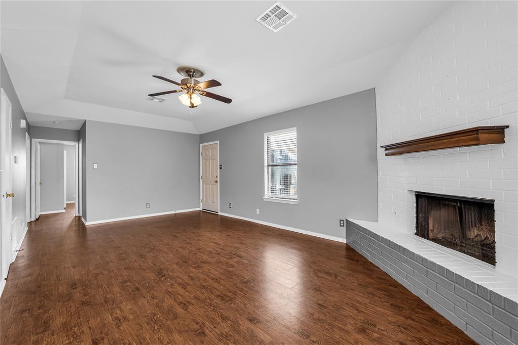 1409 Chapel Downs Waco, TX 76712 - Photo 3 of 20 a view of livingroom with fireplace wooden floor and a chandelier fan