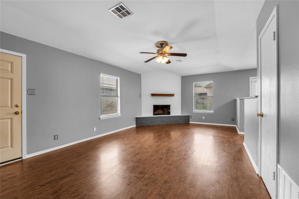 1409 Chapel Downs Waco, TX 76712 - Photo 4 of 20 an empty room with wooden floor and windows