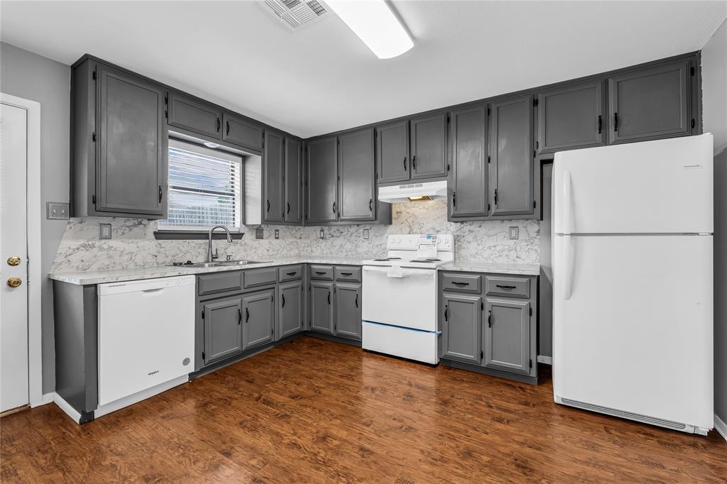 1409 Chapel Downs Waco, TX 76712 - Photo 7 of 20 a kitchen with a refrigerator sink and cabinets