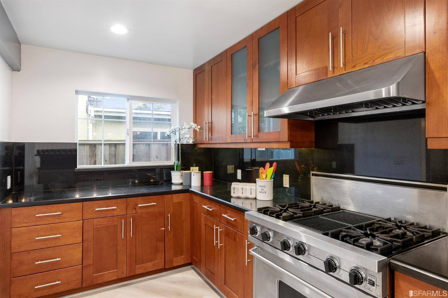 171 Beachview Avenue Pacifica, CA 94044 - Photo 22 of 52 a kitchen with granite countertop a stove and a sink