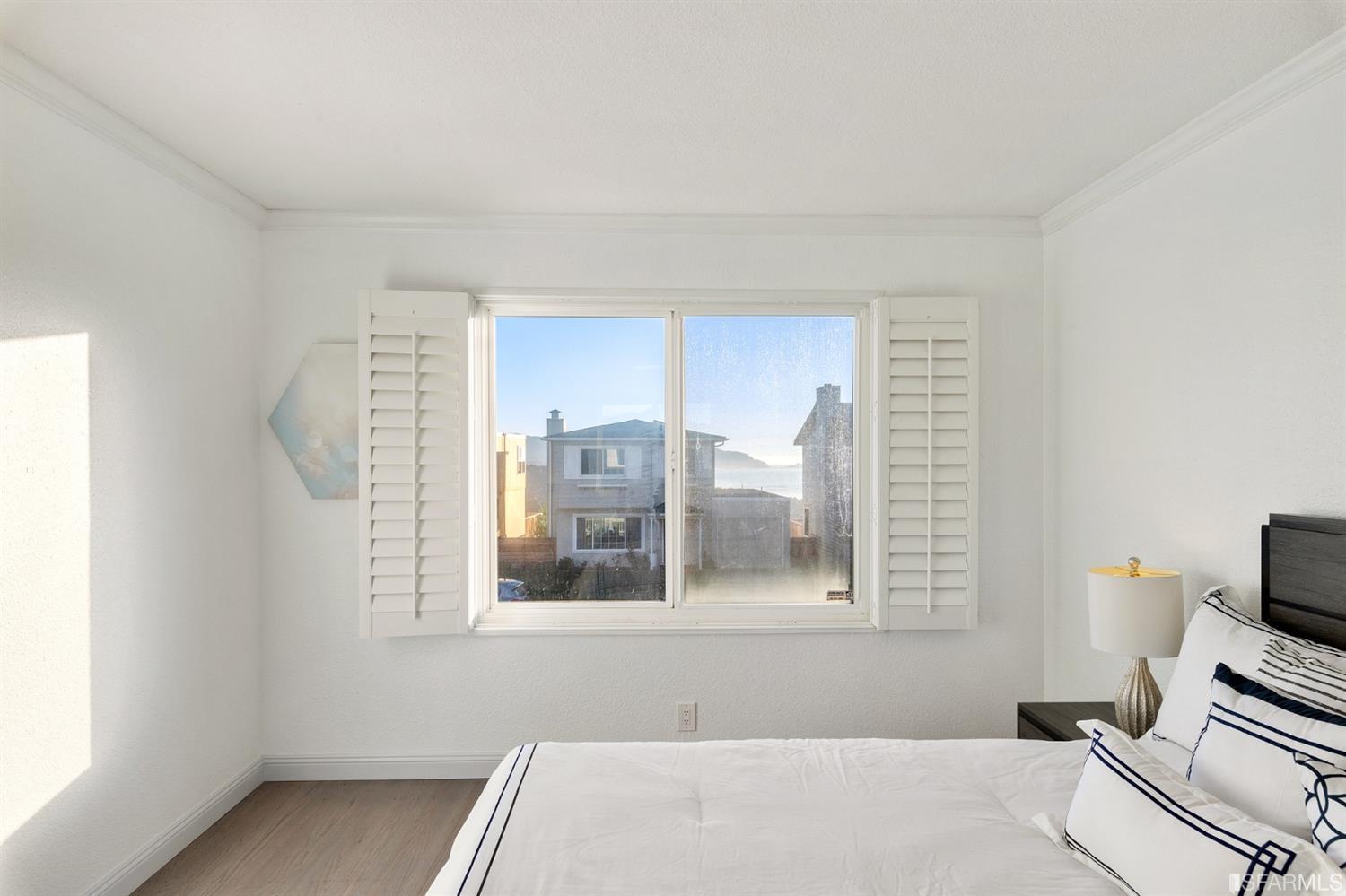 171 Beachview Avenue Pacifica, CA 94044 - Photo 35 of 52 a bedroom with a bed and a window