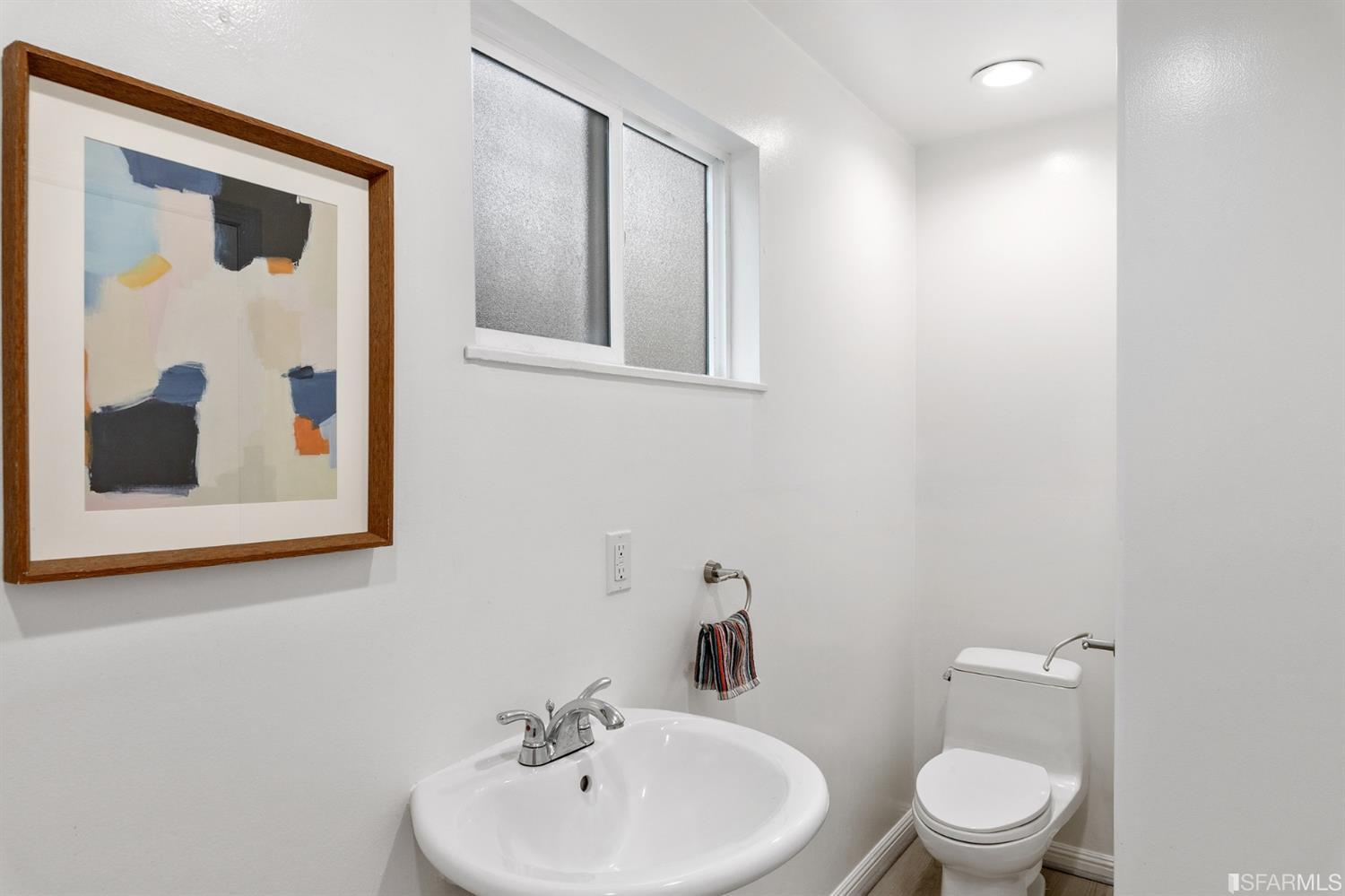 171 Beachview Avenue Pacifica, CA 94044 - Photo 43 of 52 a bathroom with a toilet sink and mirror