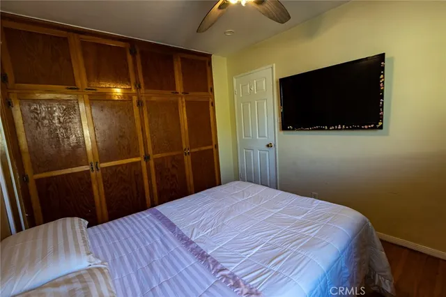 a bedroom with a bed and wooden floor