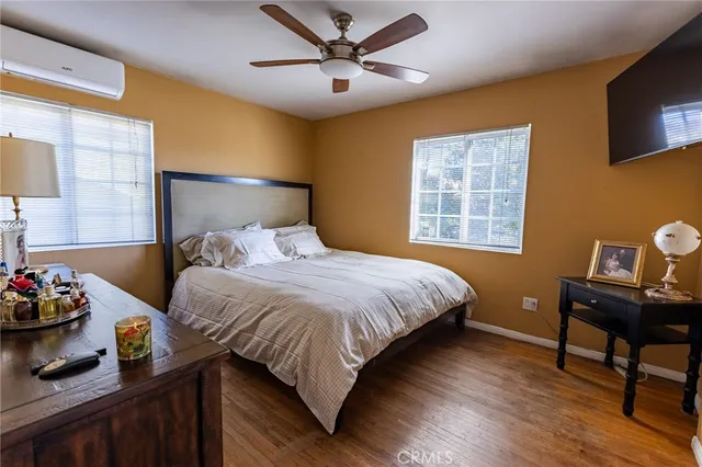 a bedroom with a bed and a tv